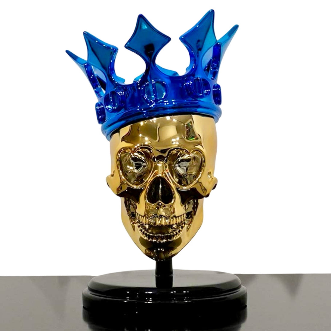 Sculpture of a golden skull with blue Christian Dior crown