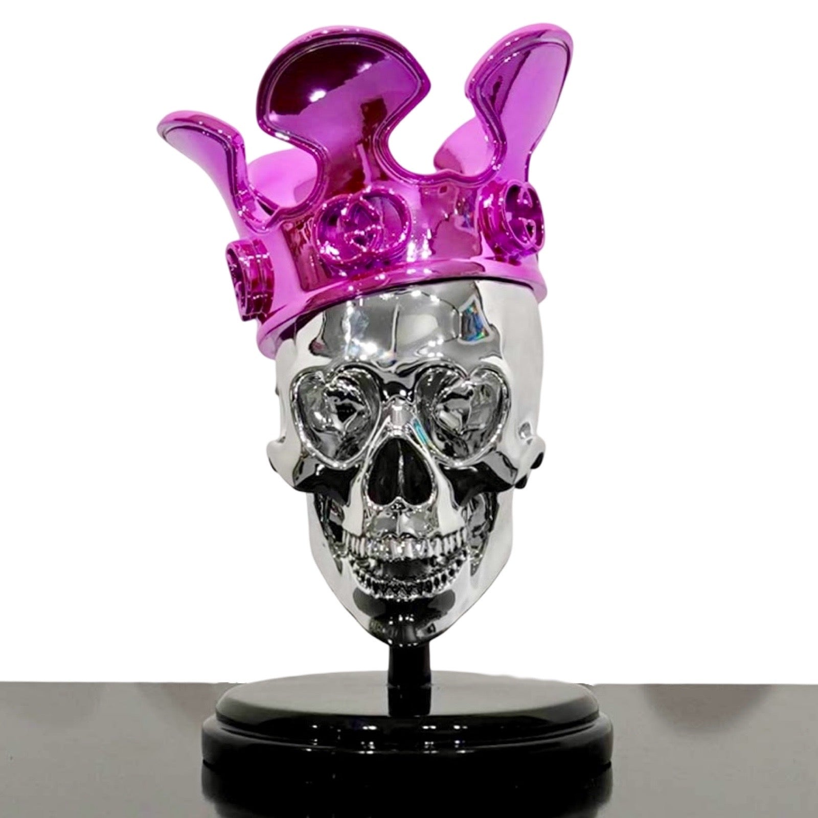 Sculpture of a silver skull with pink Gucci crown